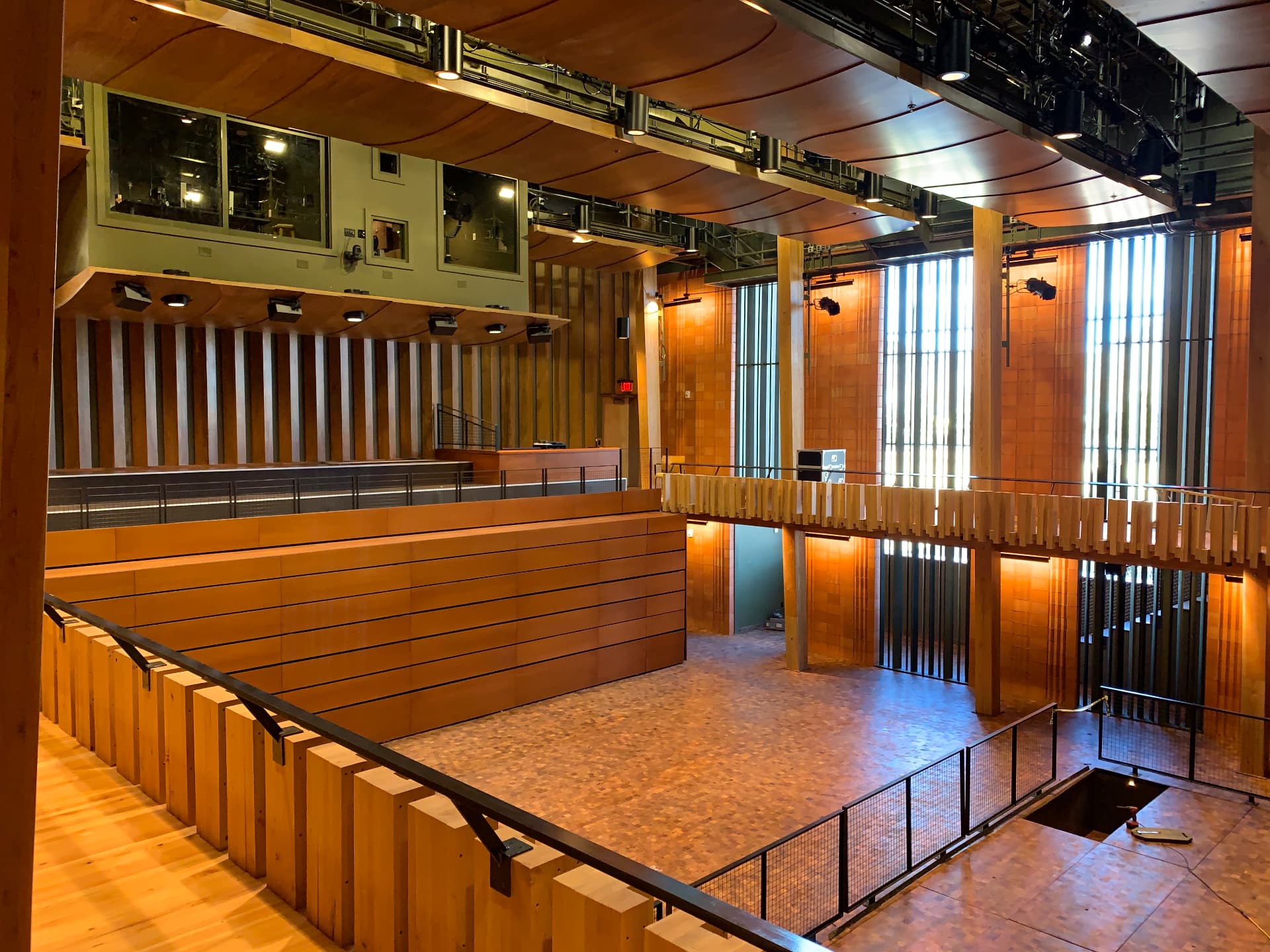 The performance hall from the balcony — catwalks, reflectors, and control booth glazing.