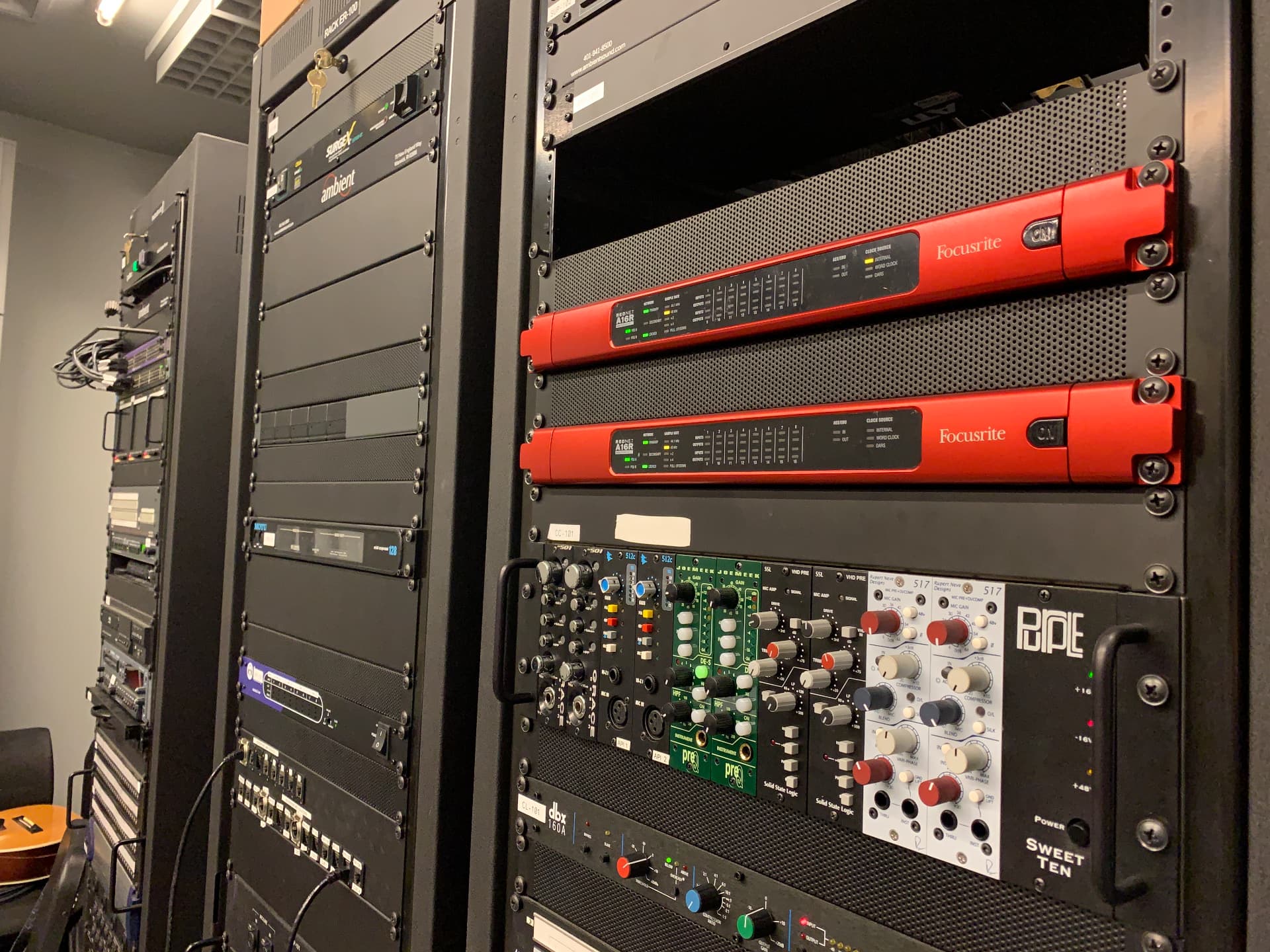 Dante interfaces and outboard preamps serving the recording suite.