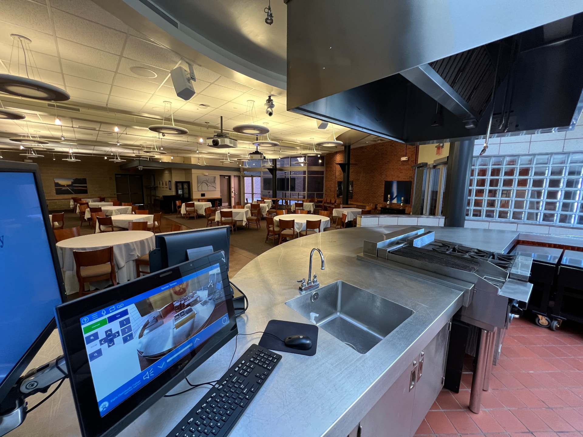 Culinary demonstration and dining venue with overhead camera, displays, and touch-panel control.