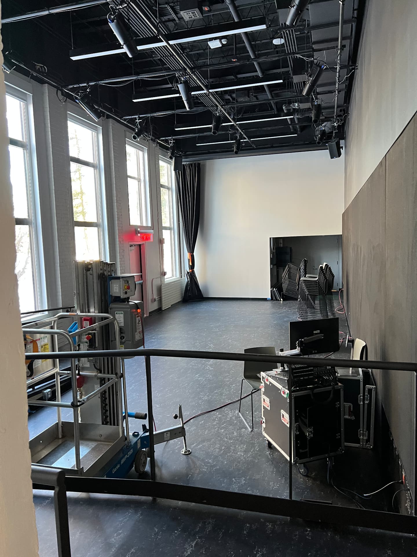 Studio and rehearsal space with technical grid and portable console rack.