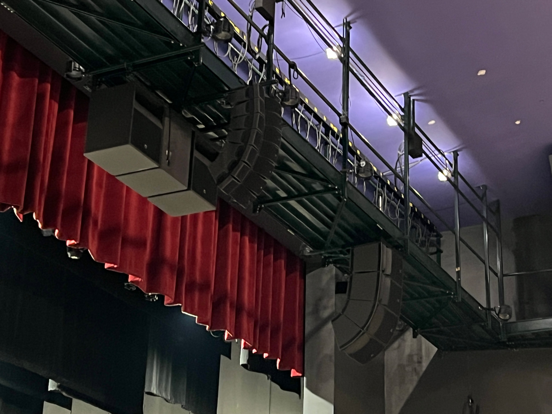 Proscenium line array and center cluster rigged from the front-of-house bridge.