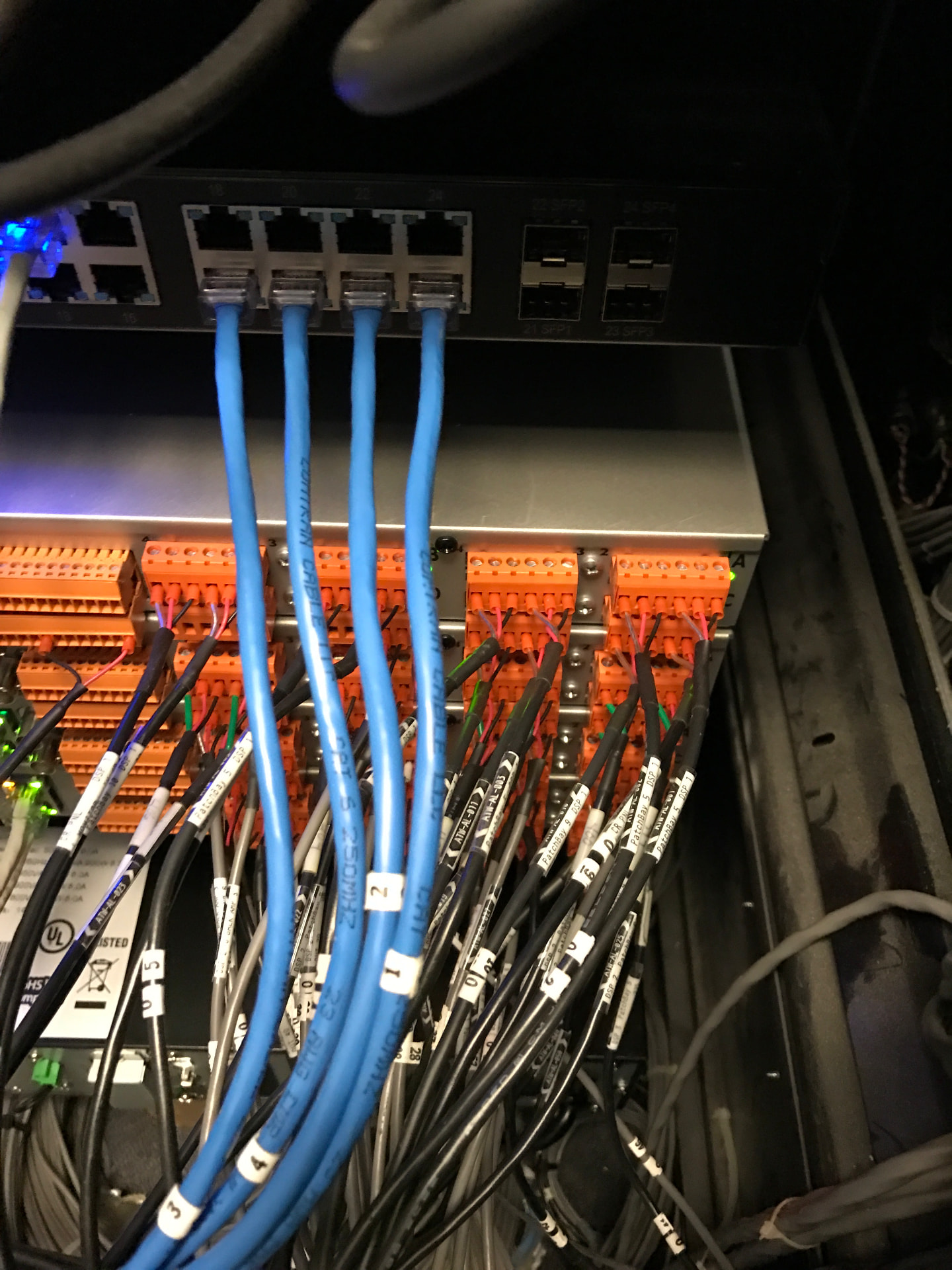 Rear of rack — network switch and DSP terminations that replaced the legacy analog distribution.