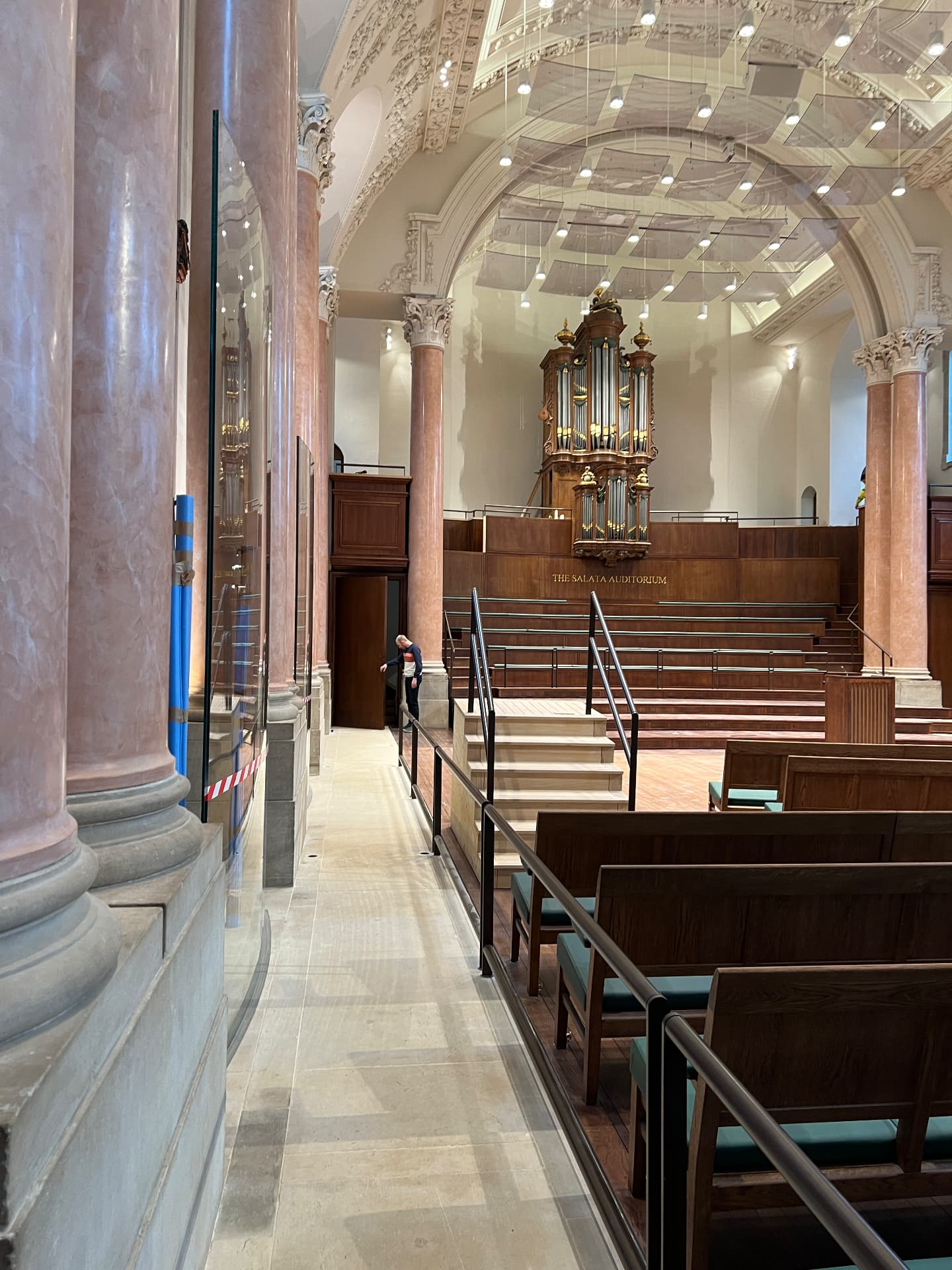 Inside Eton College’s School Hall, showing the Salata Auditorium seating, organ, and overhead acoustic reflectors.
