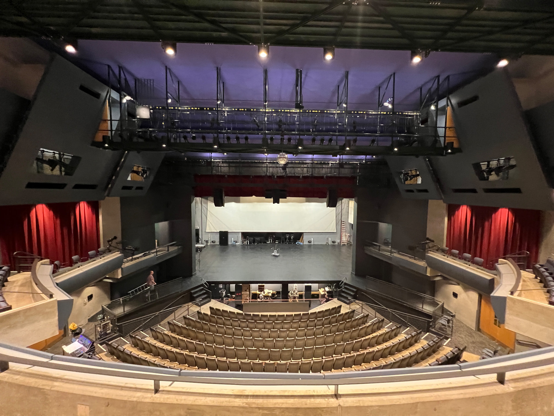 The main performance hall from the balcony, with flown arrays and catwalk positions.