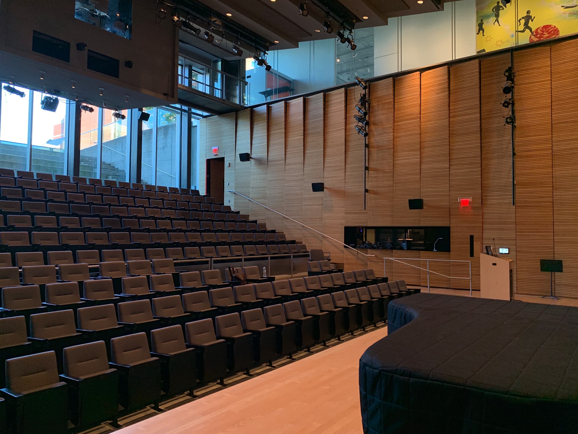 Auditorium seating and side-wall loudspeakers seen from the stage.
