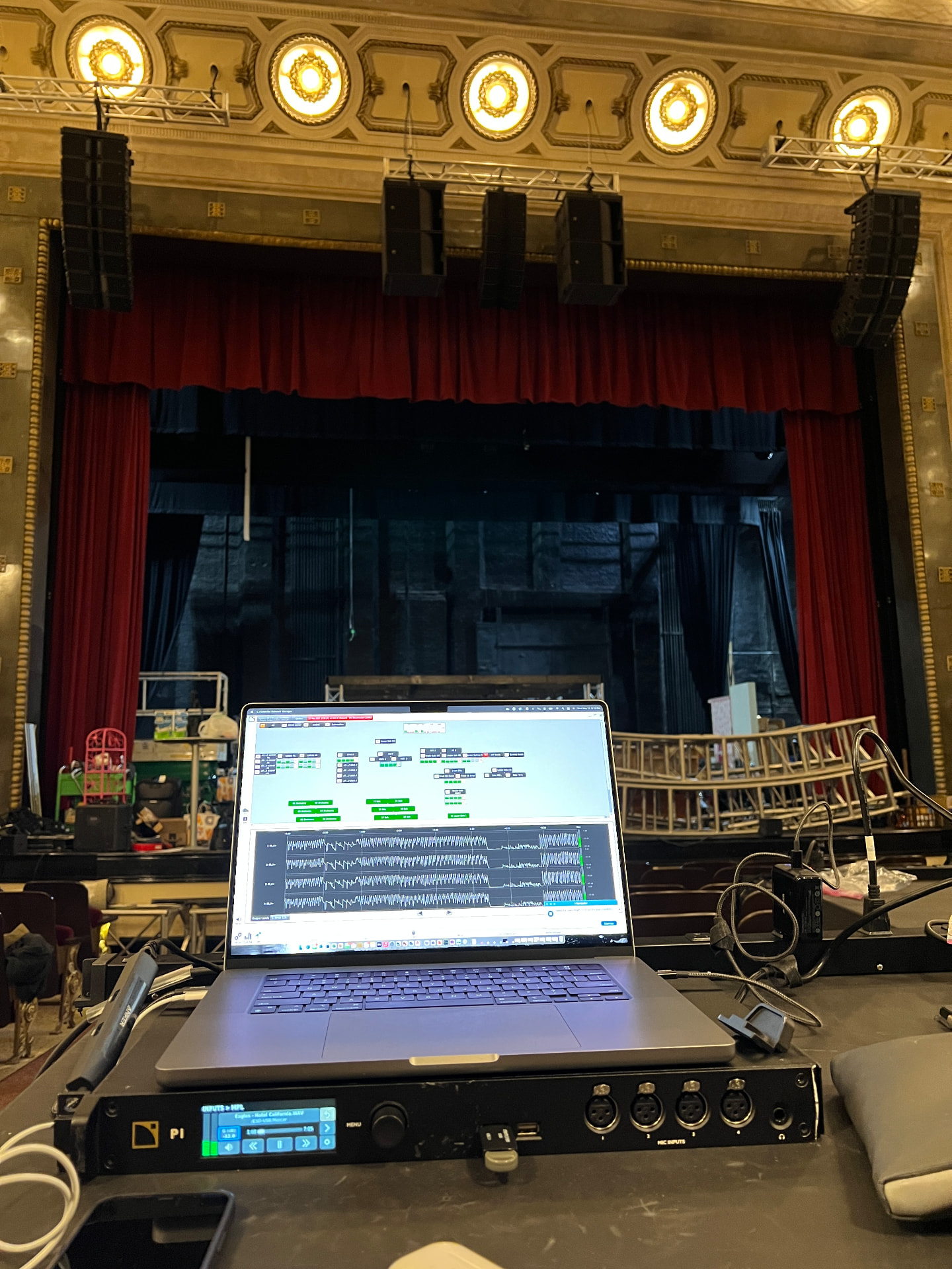 System tuning at the temporary FOH position: main and center arrays flown at the proscenium.