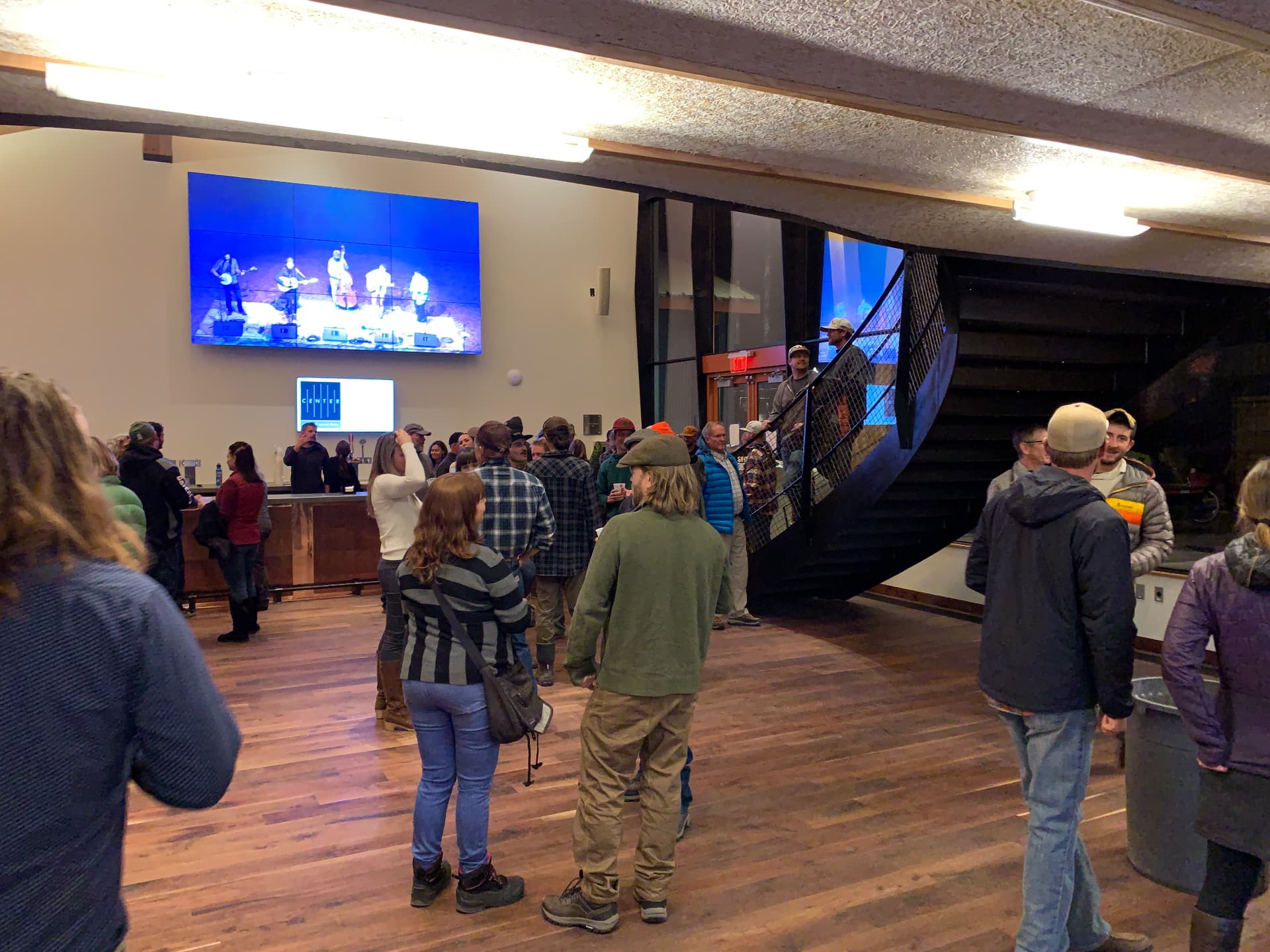 Lobby video wall carrying the live performance feed during an event.