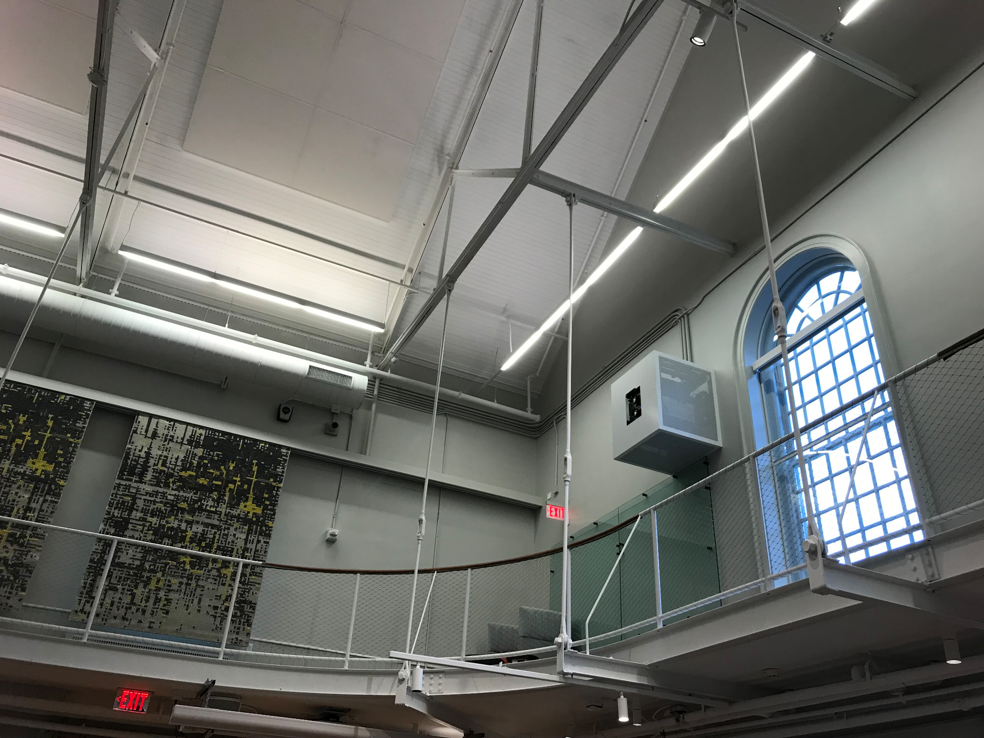 Overhead rigging, acoustic banners, and gallery level in the main hall.